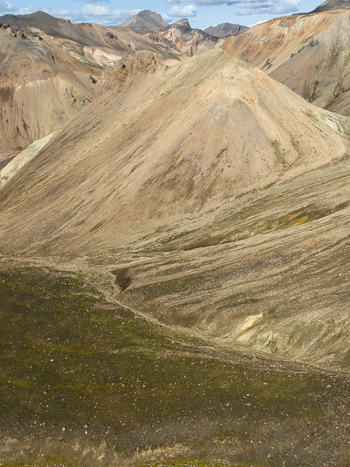 Aerial view of Landmannalaugar featuring colorful rhyolite mountains and rugged volcanic terrain in the highlands of Hella Rangarthing ytra Iceland. Aerial view of Landmannalaugar featuring colorful rhyolite mountains and rugged volcanic terrain in the highlands of Hella Rangarthing ytra Iceland.