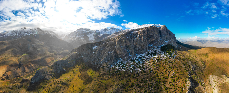 Aerial view of Aladaglar National Park featuring rugged snow capped mountain peaks rocky cliffs and sparse alpine vegetation in Demirkazik Nigde Turkey. Aerial view of Aladaglar National Park featuring rugged snow capped mountain peaks rocky cliffs and sparse alpine vegetation in Demirkazik Nigde Turkey.
