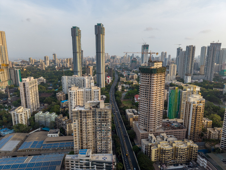 Aerial view of modern skyscrapers and high rise apartment buildings along a busy highway in the urban landscape of Mumbai Maharashtra India. Aerial view of modern skyscrapers and high rise apartment buildings along a busy highway in the urban landscape of Mumbai Maharashtra India.