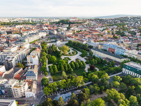 Aerial view of Freedom Square with lush green trees and surrounding urban architecture with Bratislava Castle in the distance Bratislava I Bratislavsky kraj Slovakia. Aerial view of Freedom Square with lush green trees and surrounding urban architecture with Bratislava Castle in the distance Bratislava I Bratislavsky kraj Slovakia.