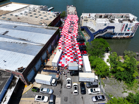 Long Island City United States 13 June 2026 Aerial view of a massive red and white checkered Croatian flag banner displayed between industrial buildings and a pier with fans gathered.