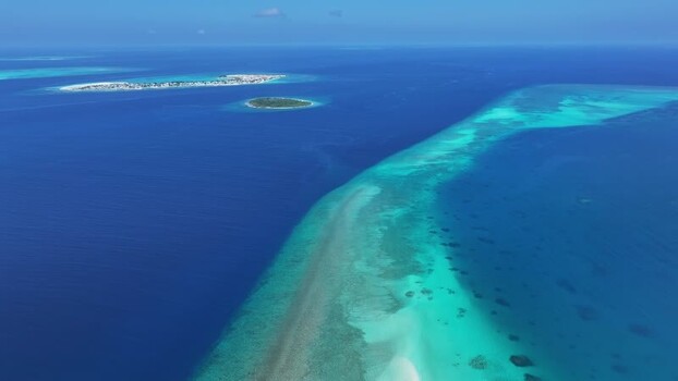 Aerial view of tropical islands and coral reefs in the Maldives. Aerial view of tropical islands and coral reefs in the Maldives.