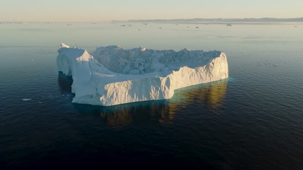 Aerial view of a large iceberg floating in the ocean Greenland. Aerial view of a large iceberg floating in the ocean Greenland.