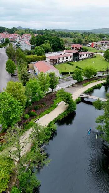 Aerial view of Rio Arnoia with kayakers and riverside paths Spain.