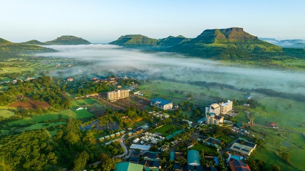 Aerial view of the town of Igatpuri nestled among lush green hills and misty valleys Igatpuri Maharashtra India.