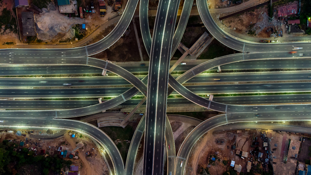 Aerial view of the Pokuase interchange featuring multi level highway ramps smooth asphalt roads and illuminated lanes at night in Ga North Municipal Greater Accra Region Ghana. Aerial view of the Pokuase interchange featuring multi level highway ramps smooth asphalt roads and illuminated lanes at night in Ga North Municipal Greater Accra Region Ghana.