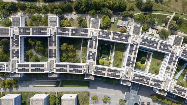 Unterfohring Germany 12 September 2026 Aerial view of the Allianz Commercial headquarters featuring interconnected office buildings with solar panel arrays on the rooftops and central green courtyards.