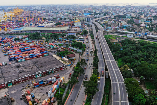 Aerial view of Chattogram Port with shipping containers industrial infrastructure and an elevated highway running through the urban landscape in Chittagong Chittagong Division Bangladesh.