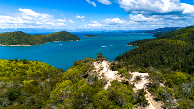 Aerial view of turquoise waters meet emerald forests and sandy trails along the coast of Abel Tasman National Park Abel Tasman National Park Tasman Region New Zealand. Aerial view of turquoise waters meet emerald forests and sandy trails along the coast of Abel Tasman National Park Abel Tasman National Park Tasman Region New Zealand.