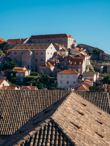 View of historic stone buildings and traditional terracotta rooftops under a clear blue sky in the historic center of Dubrovnik Old Town Dubrovnik Dubrovnik Neretva County Croatia. View of historic stone buildings and traditional terracotta rooftops under a clear blue sky in the historic center of Dubrovnik Old Town Dubrovnik Dubrovnik Neretva County Croatia.