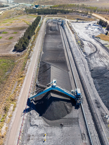 Aerial view of the Millmerran Power Station coal stockpile with a large industrial conveyor system and surrounding landscape in Domville Queensland Australia. Aerial view of the Millmerran Power Station coal stockpile with a large industrial conveyor system and surrounding landscape in Domville Queensland Australia.