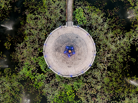 Aerial view of the circular Alun Alun Tugu Malang platform surrounded by a lotus pond with fountains in Malang East Java Indonesia.