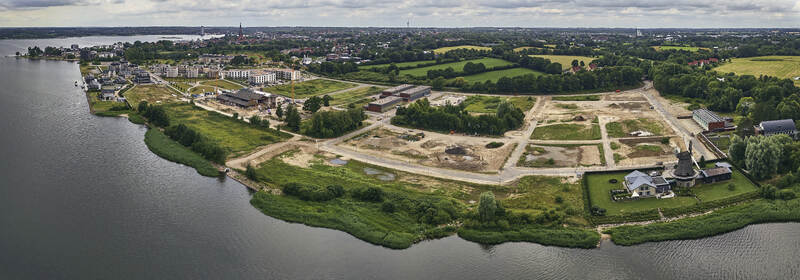 Schleswig Germany 01 July 2026 Aerial view of Windmill Nicola and the redevelopment of the former Bundeswehr Engineering base Auf Der Freiheit featuring new construction.
