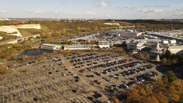 Aerial view of the Bluewater shopping centre surrounded by extensive parking lots lush greenery and chalk cliffs in Dartford England United Kingdom. Aerial view of the Bluewater shopping centre surrounded by extensive parking lots lush greenery and chalk cliffs in Dartford England United Kingdom.