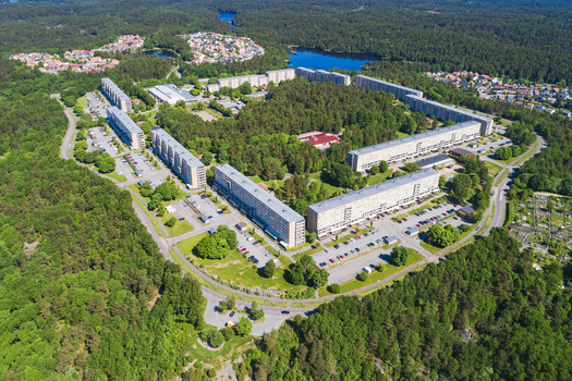 Aerial view of Rannebergen residential area with apartment blocks surrounded by dense forests and lakes in Gothenburg Vastra Gotaland County Sweden.