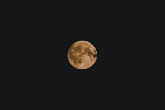 View of the full moon glowing against the dark night sky over Vormsi Laane County Estonia.