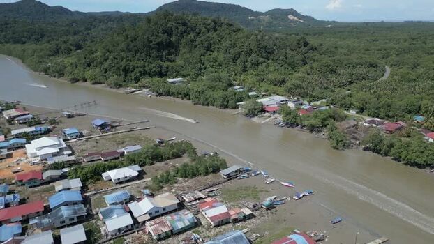 Aerial view of a river and village in Sarawak Malaysia. Aerial view of a river and village in Sarawak Malaysia.