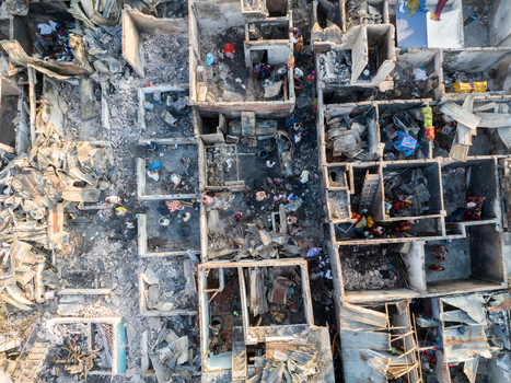 Aerial view of the stark remnants of buildings with people amid the debris contrasting destruction with resilience Dhaka Dhaka Division Bangladesh. Aerial view of the stark remnants of buildings with people amid the debris contrasting destruction with resilience Dhaka Dhaka Division Bangladesh.