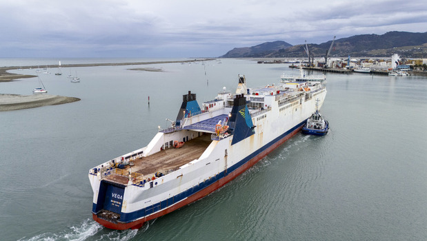 Nelson New Zealand 19 February 2026 Aerial view of the cargo ship Vega being assisted by a tugboat near Port Nelson under a cloudy sky. Nelson New Zealand 19 February 2026 Aerial view of the cargo ship Vega being assisted by a tugboat near Port Nelson under a cloudy sky.