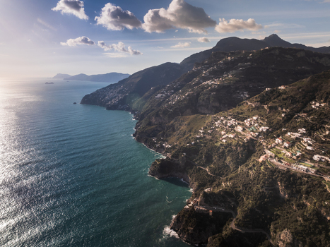 Aerial view of the Amalfi Coast s rugged cliffs meet the turquoise sea dotted with charming villages under a bright sky Amalfi Campania Italy. Aerial view of the Amalfi Coast s rugged cliffs meet the turquoise sea dotted with charming villages under a bright sky Amalfi Campania Italy.