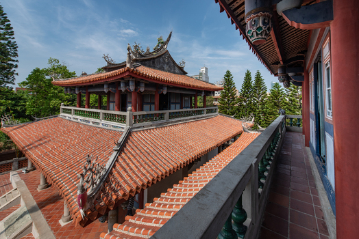 View of the traditional orange tiled roofs and ornate architecture of Chihkan Tower surrounded by lush trees in Chihkan Village Tainan City Taiwan. View of the traditional orange tiled roofs and ornate architecture of Chihkan Tower surrounded by lush trees in Chihkan Village Tainan City Taiwan.