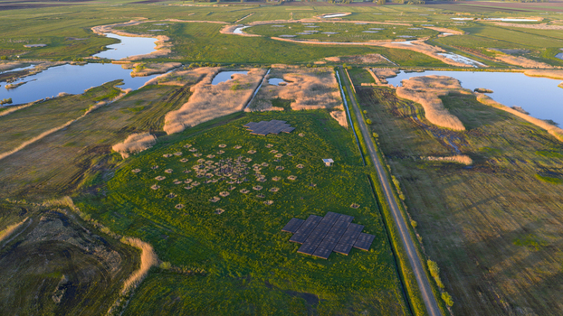 Aerial view of the LOFAR superterp radio telescope array surrounded by green fields water channels and reeds under soft light in Buinen Drenthe Netherlands. Aerial view of the LOFAR superterp radio telescope array surrounded by green fields water channels and reeds under soft light in Buinen Drenthe Netherlands.
