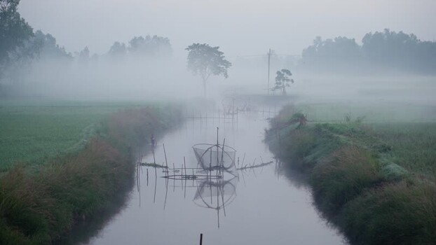 View of traditional fishing nets in a misty river Bangladesh.
