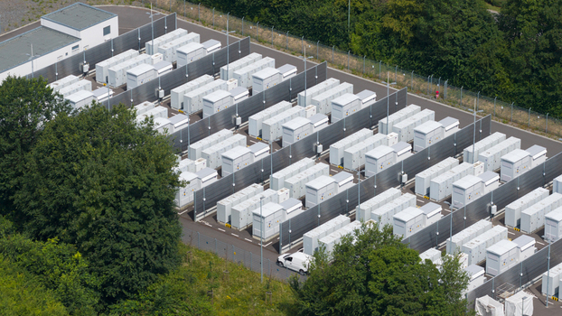 Aerial view of the RWE Power AG Kraftwerk Neurath battery storage facility with rows of white energy storage containers in a fenced site in Grevenbroich Nordrhein Westfalen Germany.