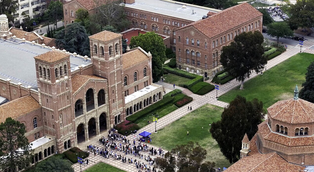 Aerial view of the historic UCLA Campus featuring Royce Hall red brick buildings manicured lawns and students walking along the pathways in Westwood California United States.