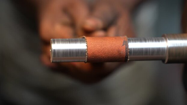 View of a metal rod being polished on a lathe Bangladesh. View of a metal rod being polished on a lathe Bangladesh.