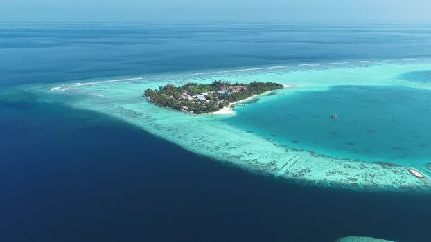 Aerial view of a tropical island and coral reef in Maldives. Aerial view of a tropical island and coral reef in Maldives.