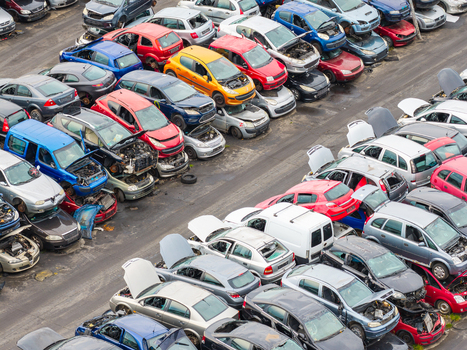 Aerial view of an end of life vehicle recycling facility with rows of salvaged cars in various colors and states of disassembly on an asphalt lot in Gdansk Pomeranian Voivodeship Poland.
