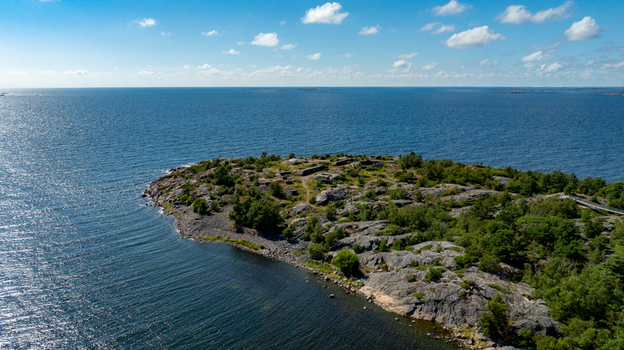 Aerial view of Oro Fortress Island featuring rocky terrain coastal vegetation and historic fortifications surrounded by the Baltic Sea in Oro Varsinais Suomi Finland. Aerial view of Oro Fortress Island featuring rocky terrain coastal vegetation and historic fortifications surrounded by the Baltic Sea in Oro Varsinais Suomi Finland.
