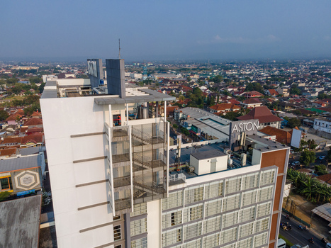 Aerial view of the Aston Hotel featuring modern architecture and rooftop signage overlooking the dense urban landscape of Purwokerto Central Java Indonesia. Aerial view of the Aston Hotel featuring modern architecture and rooftop signage overlooking the dense urban landscape of Purwokerto Central Java Indonesia.