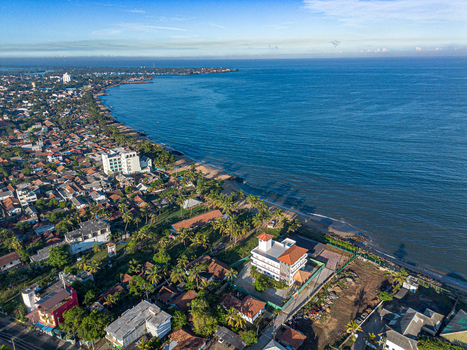 Aerial view of Negombo Beach with the coastline palm trees and urban buildings in Negombo Western Province Sri Lanka. Aerial view of Negombo Beach with the coastline palm trees and urban buildings in Negombo Western Province Sri Lanka.