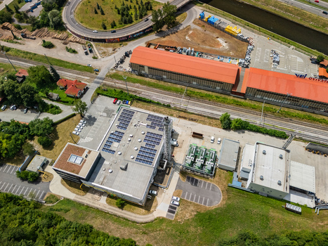Aerial view of the STEFE Banska Bystrica heating plant in Radvan with rooftop solar panels industrial chimney and railway tracks in Banska Bystrica Banskobystricky kraj Slovakia. Aerial view of the STEFE Banska Bystrica heating plant in Radvan with rooftop solar panels industrial chimney and railway tracks in Banska Bystrica Banskobystricky kraj Slovakia.