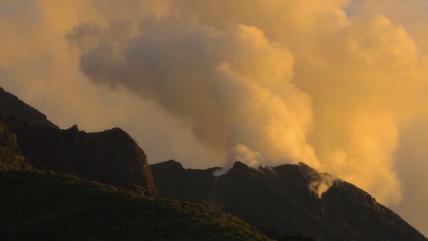 View of Stromboli volcano erupting at sunset Italy.