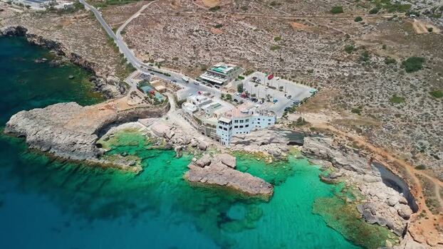 Aerial view of Ghar Lapsi Malta with turquoise coves and cliffs in summer Aerial view of Ghar Lapsi Malta with turquoise coves and cliffs in summer
