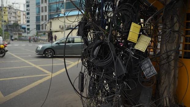 View of tangled electrical wires on a street in Dhaka Bangladesh.