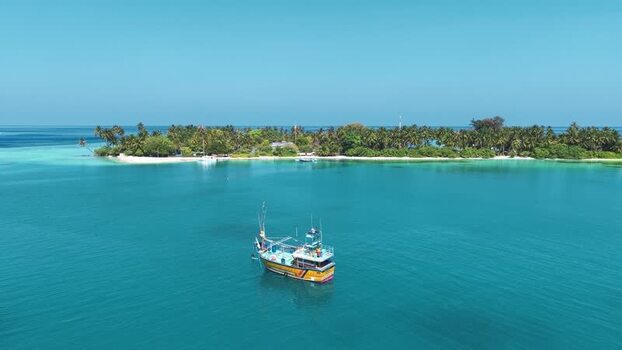 Aerial view of a fishing boat near a tropical island Maldives. Aerial view of a fishing boat near a tropical island Maldives.