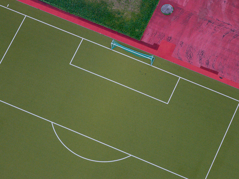 Aerial view of the High Deck Siedlung soccer field with green artificial turf and white markings in Berlin Berlin Germany. Aerial view of the High Deck Siedlung soccer field with green artificial turf and white markings in Berlin Berlin Germany.
