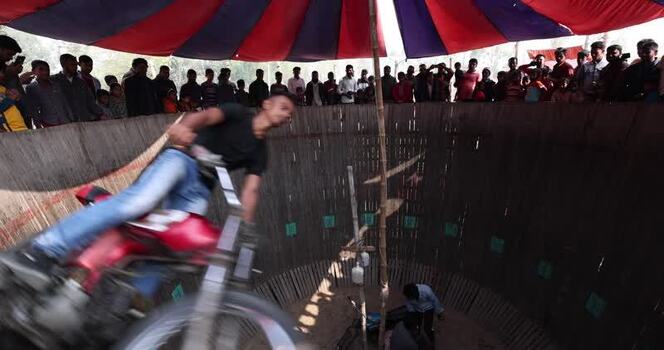 View of a motorcycle stunt performer in the Well of Death Bangladesh.