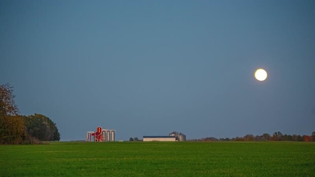View of grain silos under the full moon in Latvia.