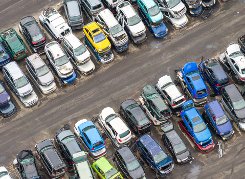 Aerial view of an end of life vehicle recycling facility with rows of salvaged cars in various colors parked on asphalt in Gdansk Pomeranian Voivodeshi Poland. Aerial view of an end of life vehicle recycling facility with rows of salvaged cars in various colors parked on asphalt in Gdansk Pomeranian Voivodeshi Poland.
