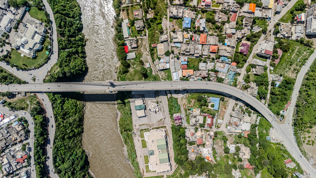 Aerial view of a bridge spanning a river in the urban landscape of Muzaffarabad Azad Kashmir Pakistan. Aerial view of a bridge spanning a river in the urban landscape of Muzaffarabad Azad Kashmir Pakistan.