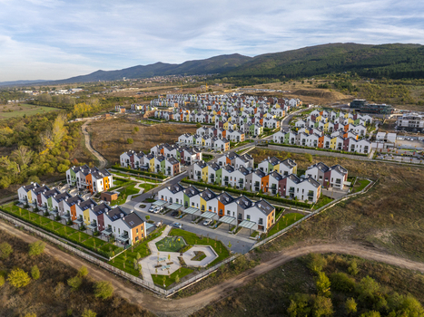 Aerial view of Residential Park Lozen featuring modern colorful houses with green lawns and paved streets set against a backdrop of rolling hills in Sofia Sofia City Province Bulgaria. Aerial view of Residential Park Lozen featuring modern colorful houses with green lawns and paved streets set against a backdrop of rolling hills in Sofia Sofia City Province Bulgaria.