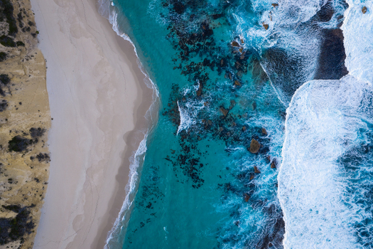 Aerial view of Salmon Holes with turquoise ocean water white sandy beach and rocky coastline in Torndirrup Western Australia Australia.