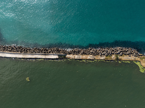 Aerial view of the Rio Ozama breakwater with concrete tetrapods separating the river from the Caribbean Sea in Santo Domingo Santo Domingo Dominican Republic.