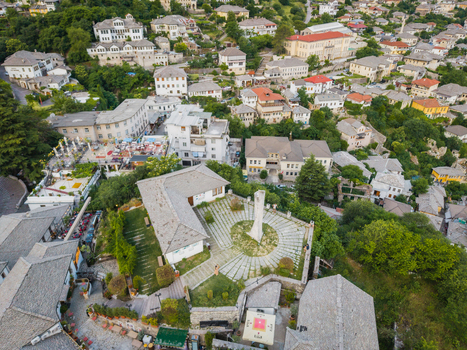 Aerial view of the historic Ottoman era stone houses with grey slate roofs and the central obelisk monument in the old town of Gjirokaster Gjirokaster County Albania. Aerial view of the historic Ottoman era stone houses with grey slate roofs and the central obelisk monument in the old town of Gjirokaster Gjirokaster County Albania.
