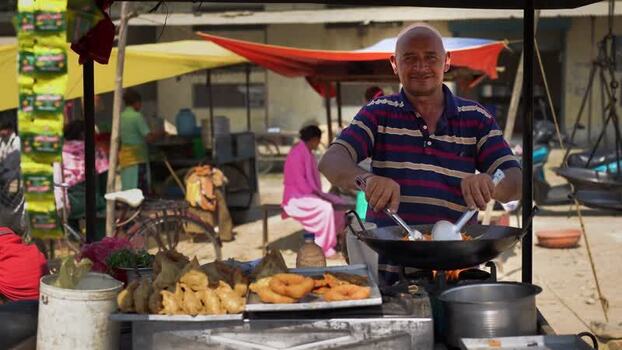 View of a street food vendor cooking in a wok in Dhangadhi Nepal. View of a street food vendor cooking in a wok in Dhangadhi Nepal.
